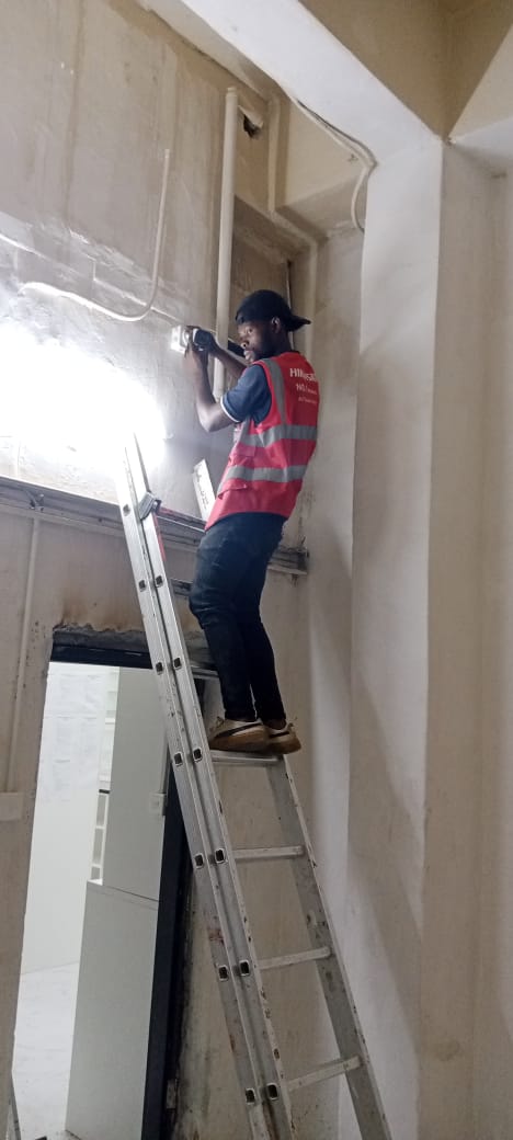 Bytecraft technician installing security equipment above an entrance in Lusaka